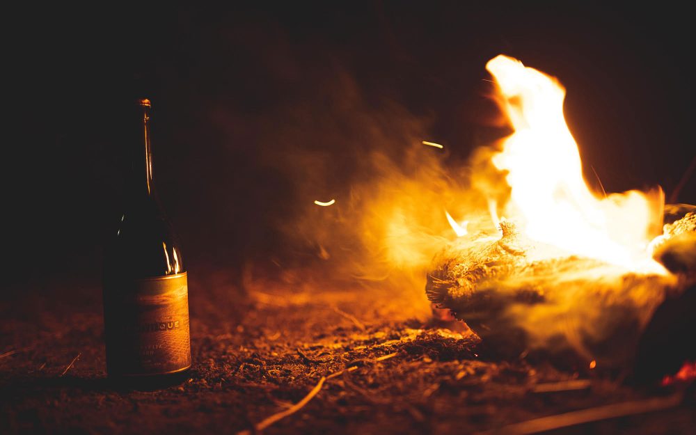 Bottle of Authentique wine by fire light